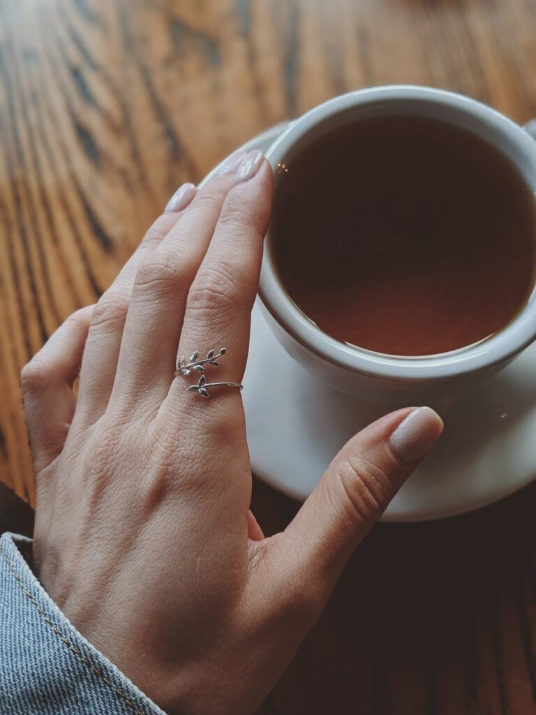 a hand over a cup of tea