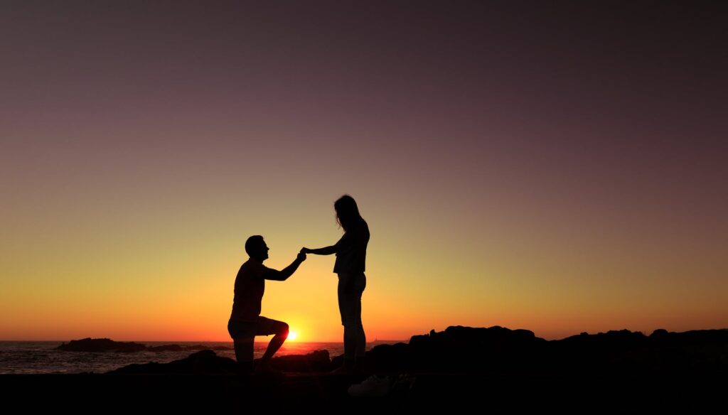 silhouette of a man proposing to a woman