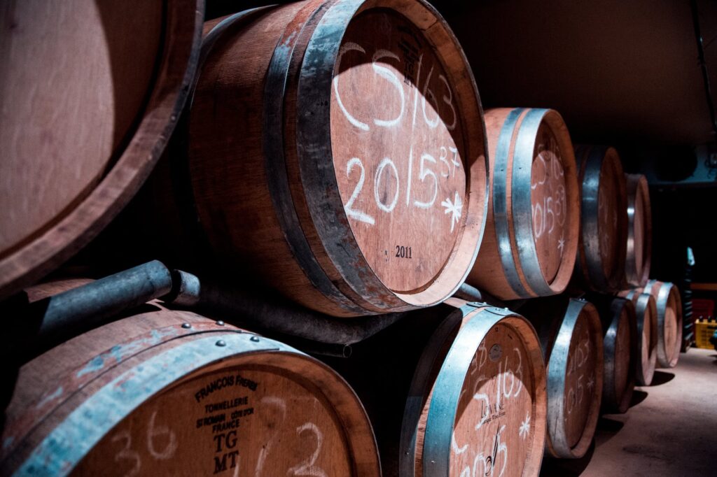 pile of brown wooden barrels